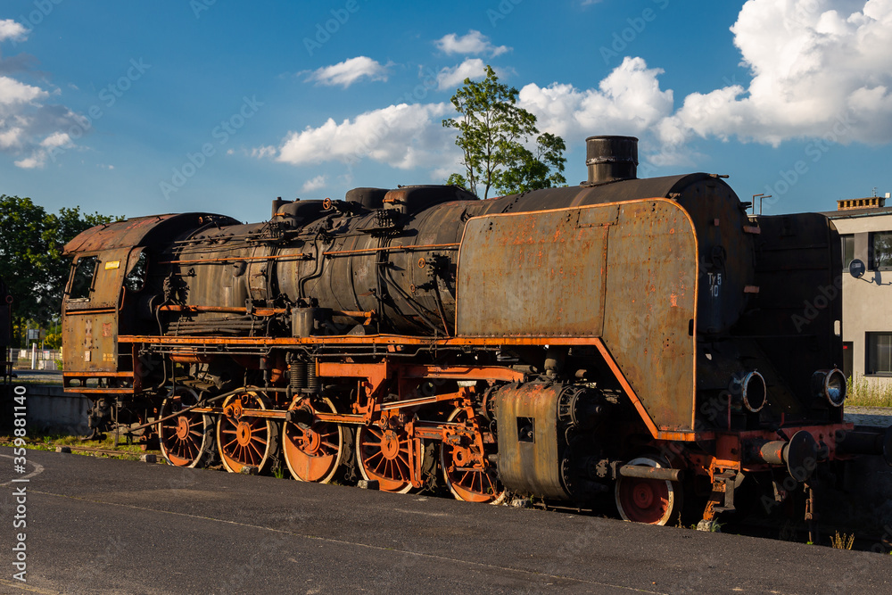Old, rusty steam locomotive standing on the station