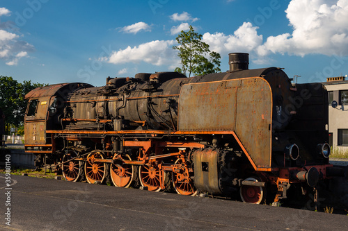 Old, rusty steam locomotive standing on the station