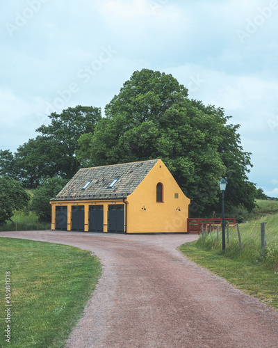 Yellow horse carriage stable converted into office space in a park in Landskrona, Sweden
