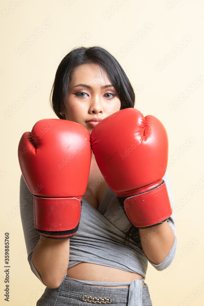 Young Asian woman with red boxing gloves. Young Asian woman with red boxing gloves.