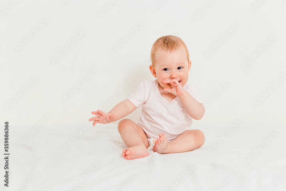 Baby in T-shirt and diaper sucking fingers Baby in T-shirt and diaper sucking fingers