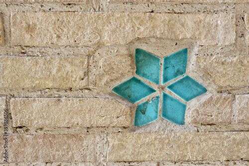 Aragon typical wall made of sand colored brick and blue tile ceramic decorative elements in Mudejar muslim style photo