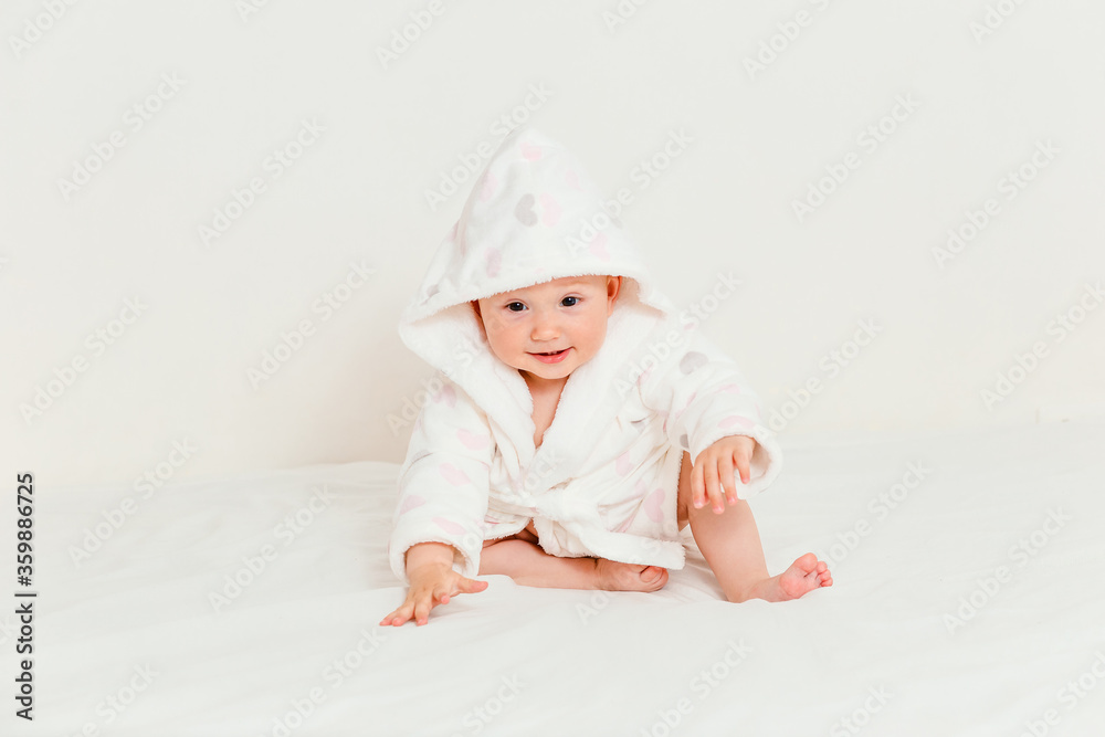 Baby less than a year old in a bathrobe after swimming Baby less than a year old in a bathrobe after swimming