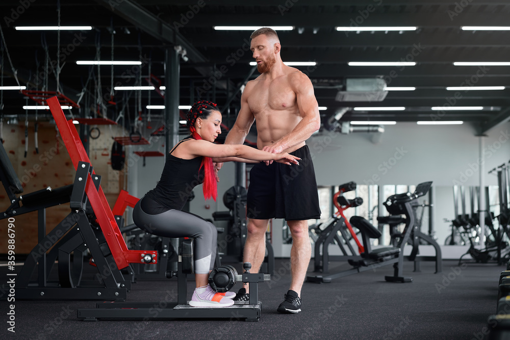 Personal trainer coach instructor athlete sportive man woman gym Boyfriend girlfriend training together Personal trainer coach instructor athlete sportive man woman gym Boyfriend girlfriend training together