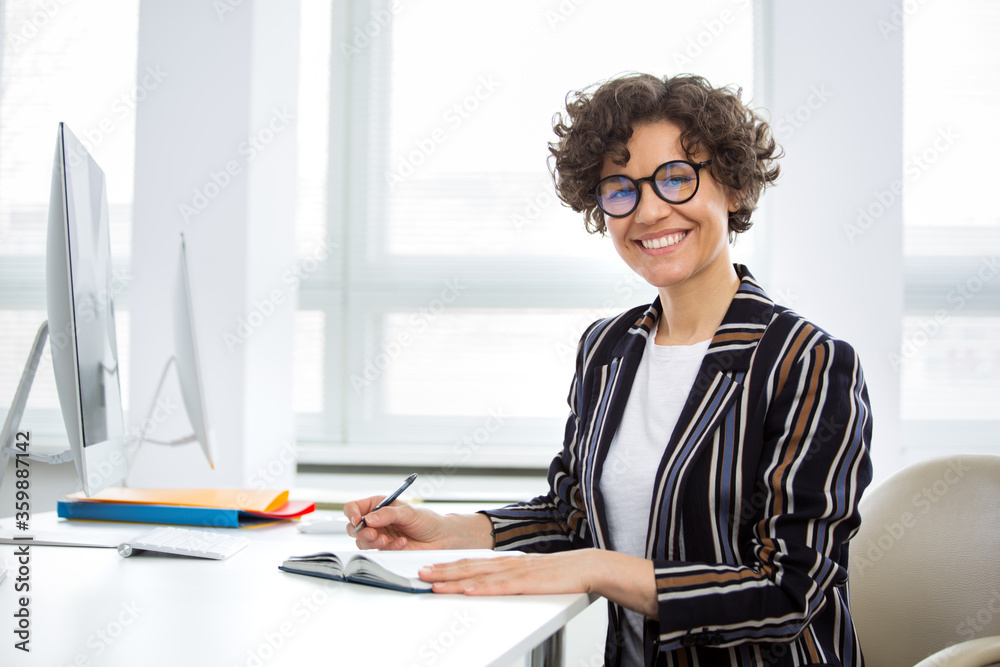 Portrait of a business woman at workplace in office Portrait of a business woman at workplace in office