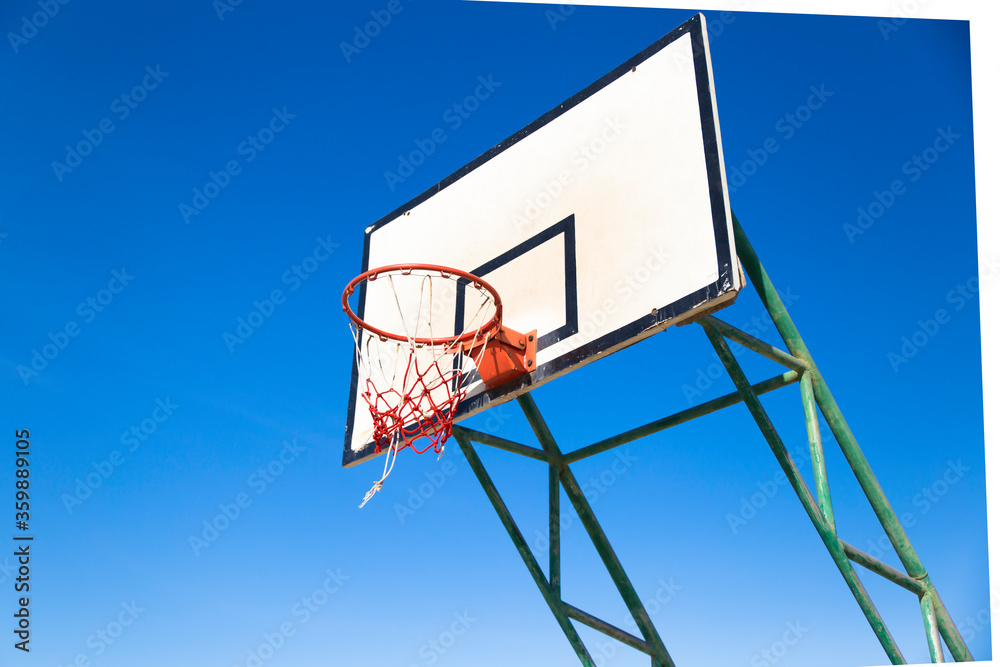 Basket on blue background,baseketball hoop
Close-up of basketball rim and net  
