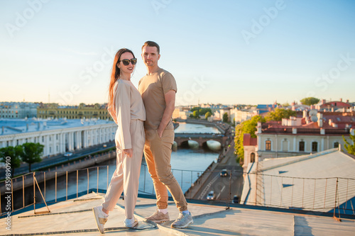 Family on rooftop enjoying with view of beautiful sunset in Sankt Petersburg in Russia