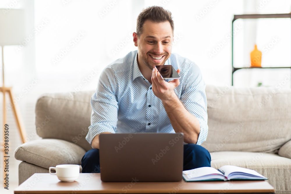 Young handsome man using voice assistant on cell phone Young handsome man using voice assistant on cell phone