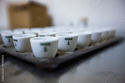 White technical porcelain metal sample test cups in the chemical lab of the gold manufacturing plant. Mining and processing plant laboratory. Low depth-of-field photo. Altynalmas company. Kazakhstan.