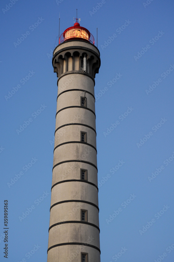 High lighthouse on the background of Purple sky, free space