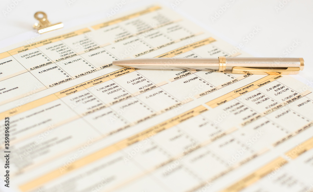 glasses and financial documents are on the table glasses and financial documents are on the table