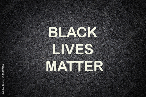 Black lives matter lettering card on black concrete background