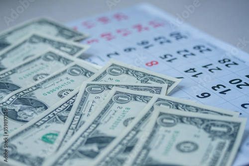 Banknotes of dollars on calendar sheets closeup
