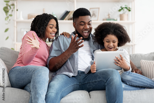 Cheerful African Family Having Fun With Digital Tablet At Home