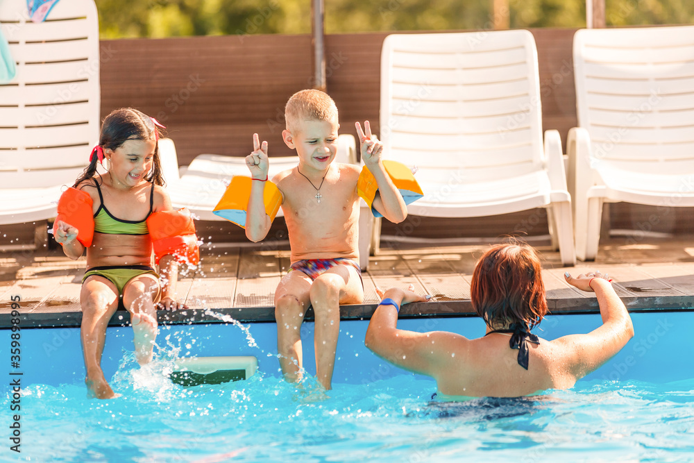 mother and children in the pool mother and children in the pool