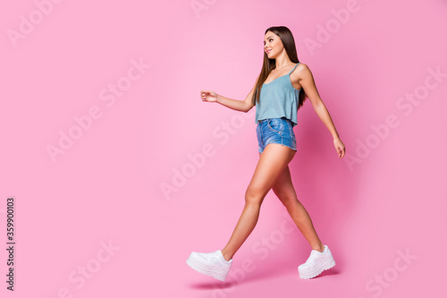 Full length body size view of her she nice-looking attractive lovely pretty gorgeous slender cheerful content brown-haired girl walking isolated over pink pastel color background