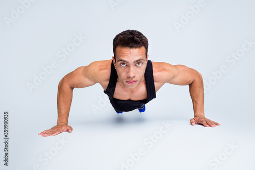 Close-up portrait of his he nice attractive sportive strong dedicated macho guy doing push-ups motivation goal training delta muscle isolated over light gray pastel color background