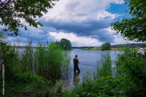 angler catching the fish during stormy weather