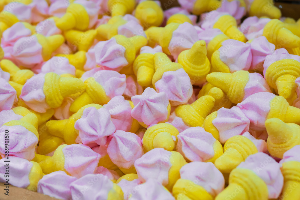 Obraz premium Background - assortment of delicious marmalade jelly candies looks like ice cream cones for sale on counter of shop, market, cafe. Dessert, copy space, sweet food, pattern, confectionery concept