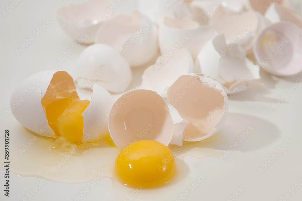 broken eggs and eggshells on a light background broken eggs and eggshells on a light background