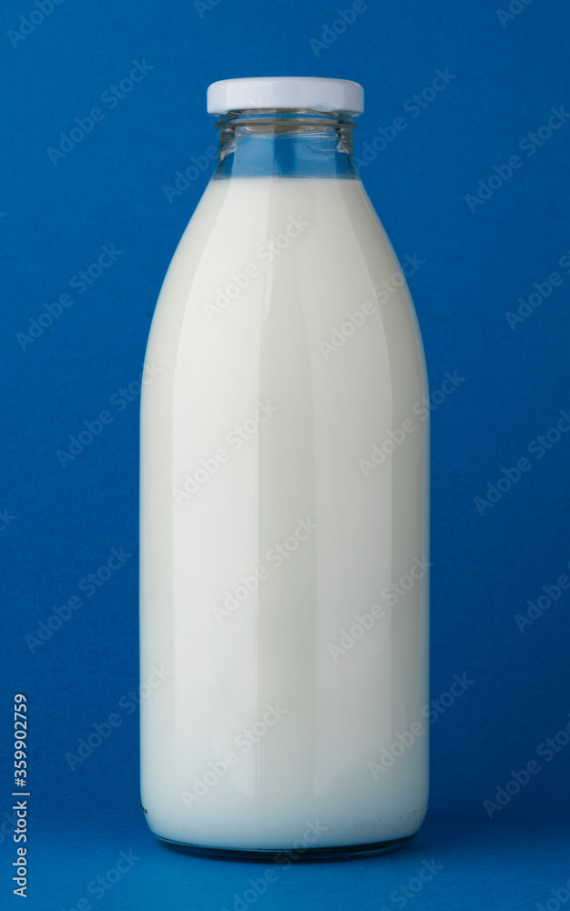 Glass milk bottle mock up on blue background Glass milk bottle mock up on blue background