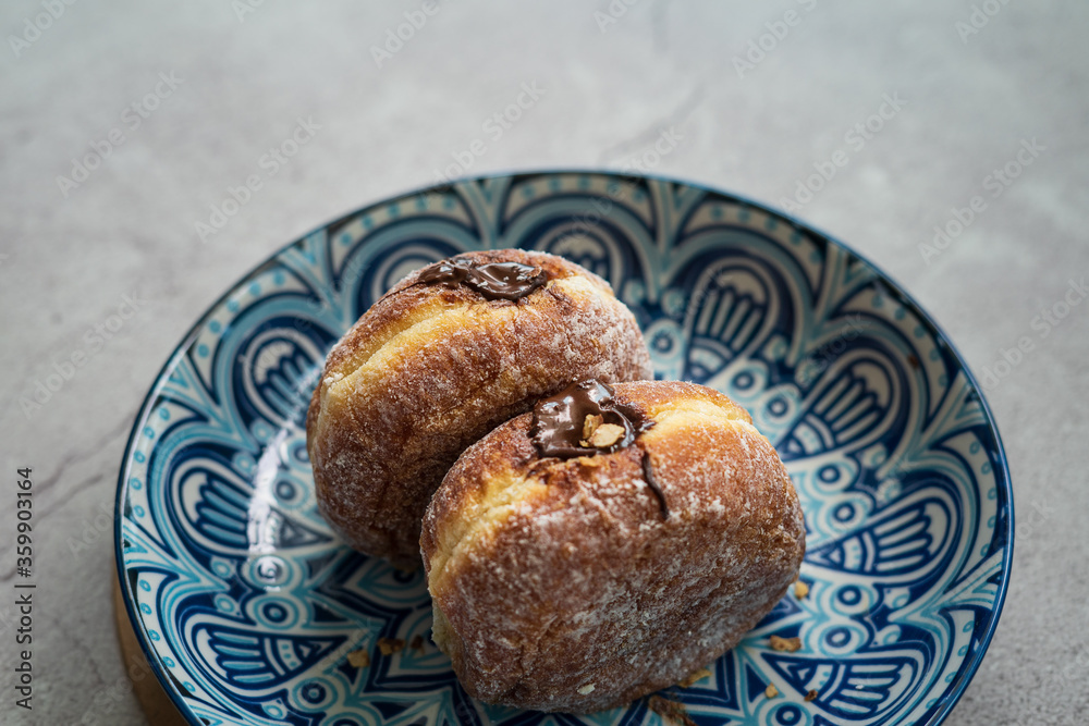 Bomboloni, a donut filled with melted chocolate and eaten as a snack