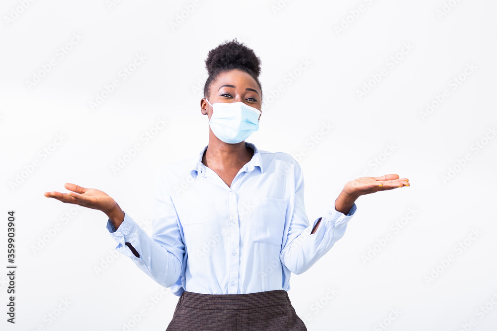 Studio portrait of young business woman wearing a face mask, looking at camera, close up, isolated on gray background. Flu epidemic, dust allergy, protection against virus. City air pollution concept Studio portrait of young business woman wearing a face mask, looking at camera, close up, isolated on gray background. Flu epidemic, dust allergy, protection against virus. City air pollution concept
