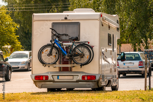 Two pleasure bikes are strapped to the back of the camper van