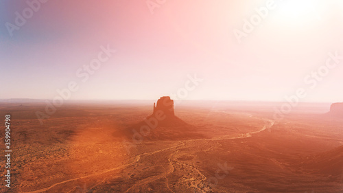 Bird's eye scenery view of unique geological formation of Arizona landmark. Monument Valley rocks one of the National symbols of the United States of America. Sandy desert landscape with roads
