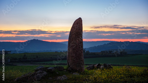 menhir in spain at the fall of the sun photo