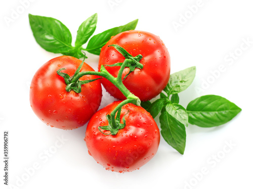 Red tomato and basil isolated on white background