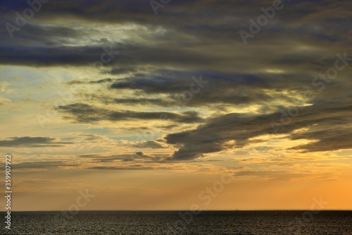 A narrow strip of clear sky over the horizon. The sky is covered with dense clouds.