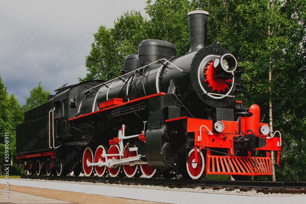 Fototapeta premium Old classical black and red vintage steam locomotive, locomotive monument in Russia Siberia.