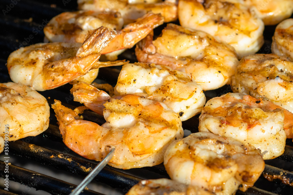 Skewers of seasoned shrimp grilled to delicious golden hues on the gas grill during a Wisconsin cookout.