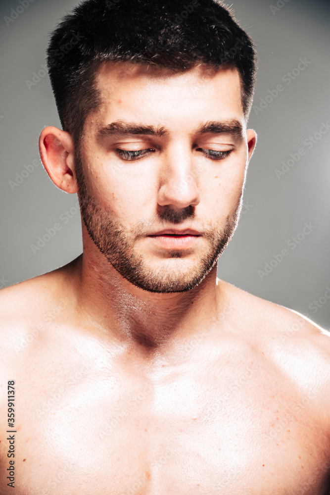 Lifestyle closeup portrait of attractive handsome shirtless young man posing in photo studio Lifestyle closeup portrait of attractive handsome shirtless young man posing in photo studio