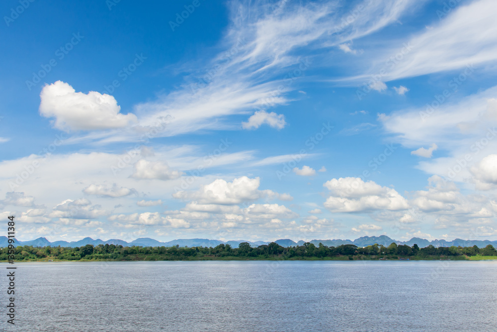 River and cirrus, cumulus clouds on blue sky background.