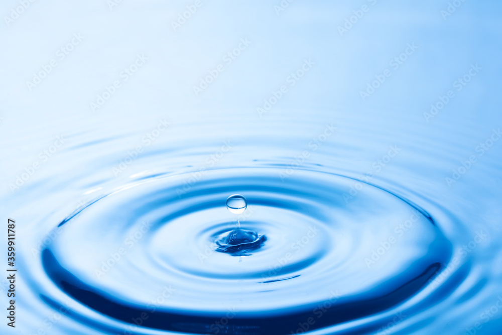 Water droplet falling impact with water surface. causing rings on water surface. Water droplet falling impact with water surface. causing rings on water surface.