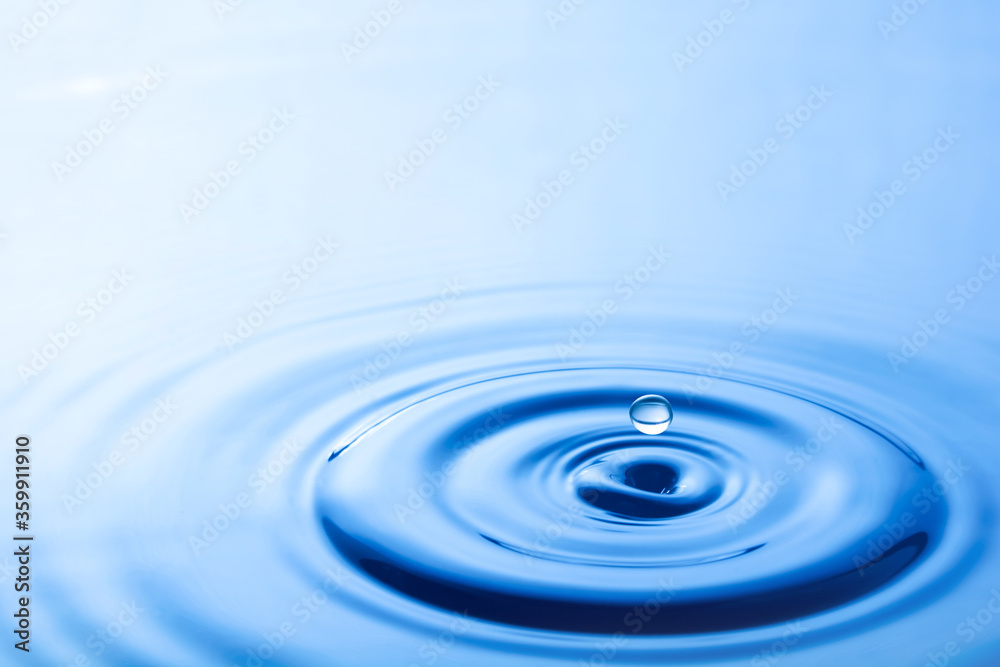 Water droplet falling impact with water surface. causing rings on water surface. Water droplet falling impact with water surface. causing rings on water surface.