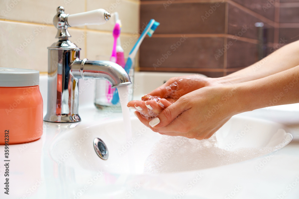 Woman washing her hands with soap close up Woman washing her hands with soap close up