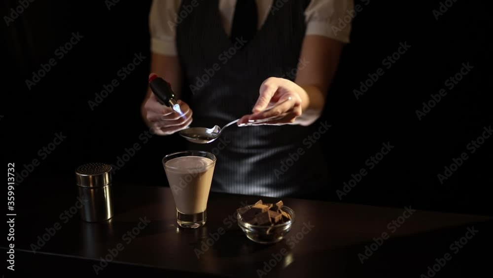 Bartender setting Baileys comet cocktail on fire Bartender setting Baileys comet cocktail on fire