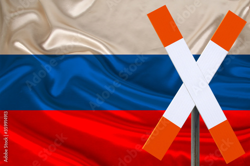 customs sign, stop, attention on the background of the silk national flag of Russia, the concept of border and customs control, violation of the state border, tourism restrictions