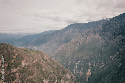 Beautiful background with green mountains and cloudy sky in Colca Canyon, Peru