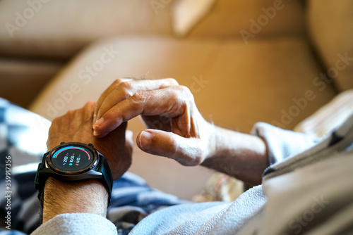 old man checking his condition on his smart watch