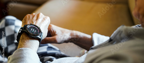 old man checking his condition on his smart watch