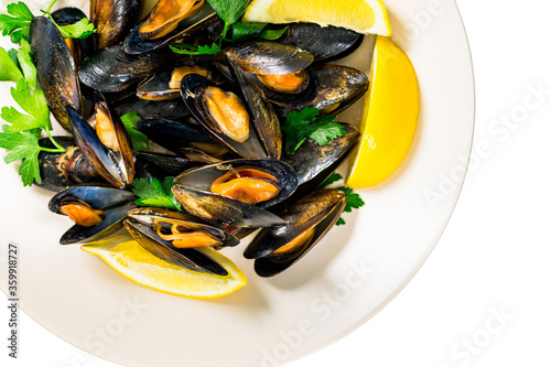 Delicious Seafood Mussels with Lemon and Parsley. Clams in the Shells Isolated on White Background. Selective focus.