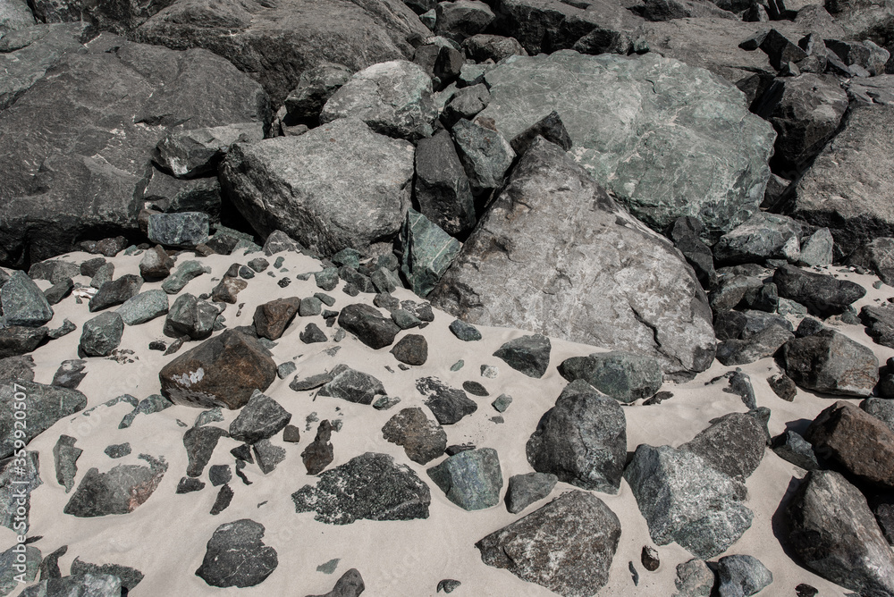 Grey stones background. Rocky beach. Sand texture