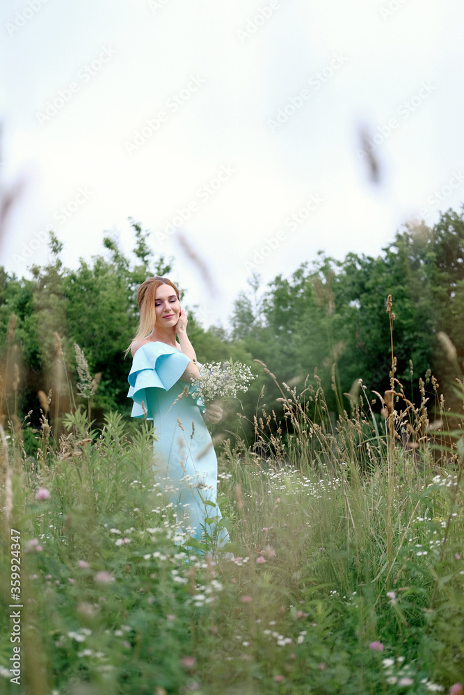 Young woman with flowers in the park posing Young woman with flowers in the park posing
