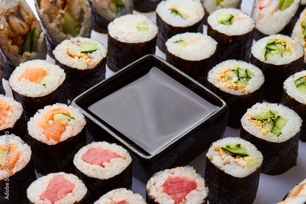 Various kinds of sushi roll set served on cutting board. Japanese food Various kinds of sushi roll set served on cutting board. Japanese food