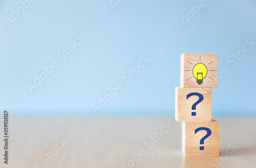 Cubes dice with light bulb and question mark faqs.