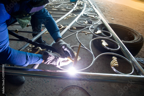 Fototapeta Naklejka Na Ścianę i Meble -  Welders are welding the various parts of building a stainless steel door.